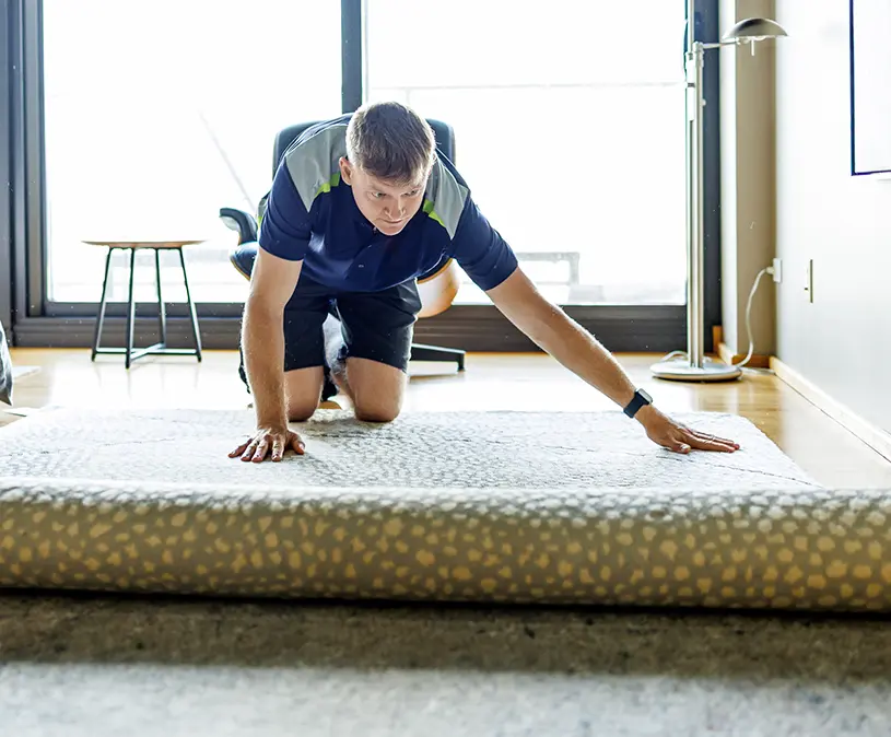 Expert technician inspecting an area rug